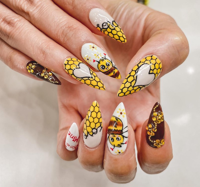 Bee nail design in bright yellow and dark brown