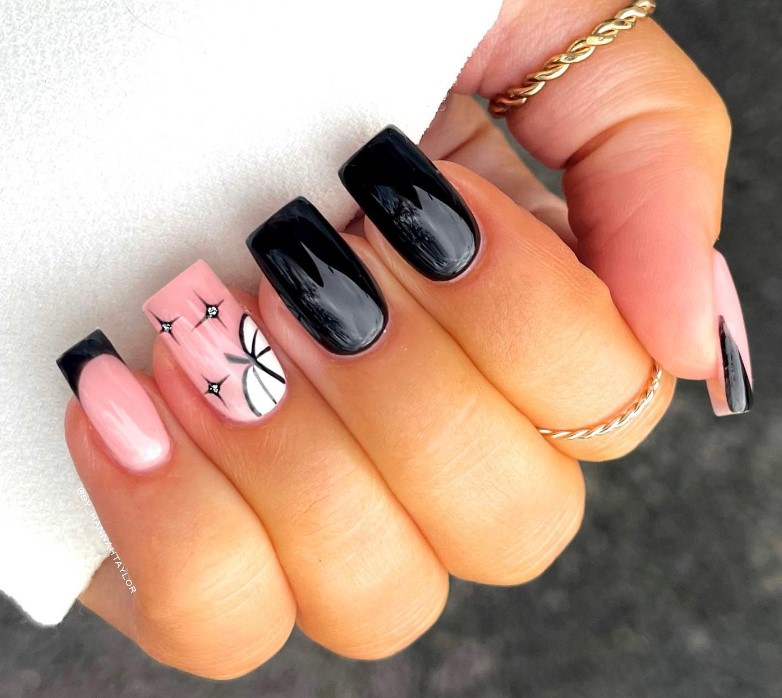 white pumpkin on one nail and black nails