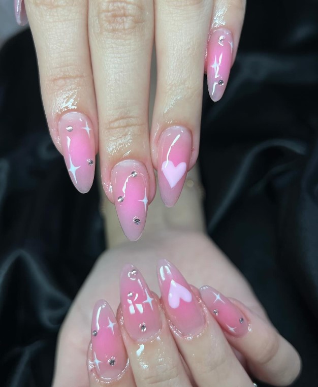 pink aura nails with little hearts