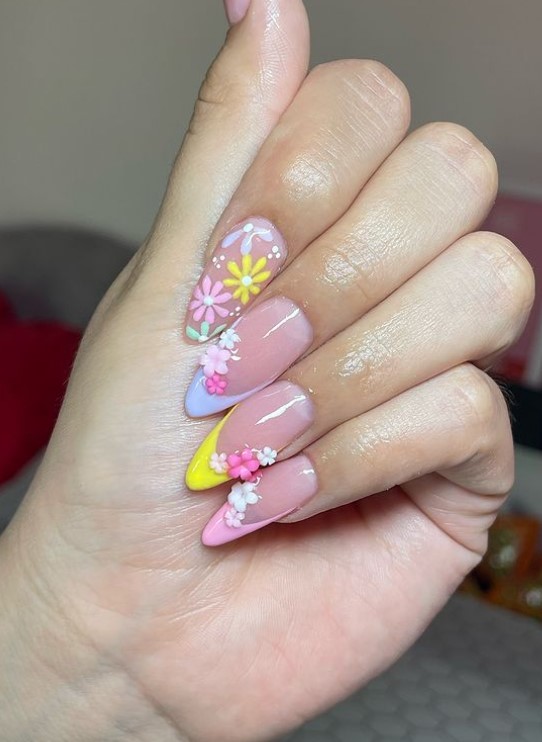 Almond shaped French nails with colorful daises