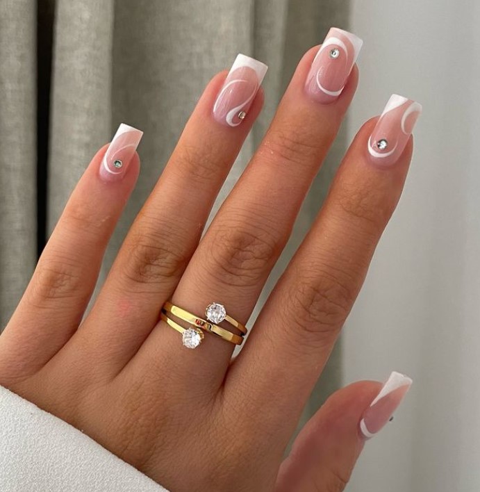 White design on blush nails