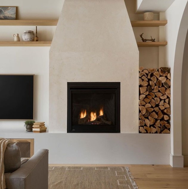 Fireplace in Living room with lOgs on Side