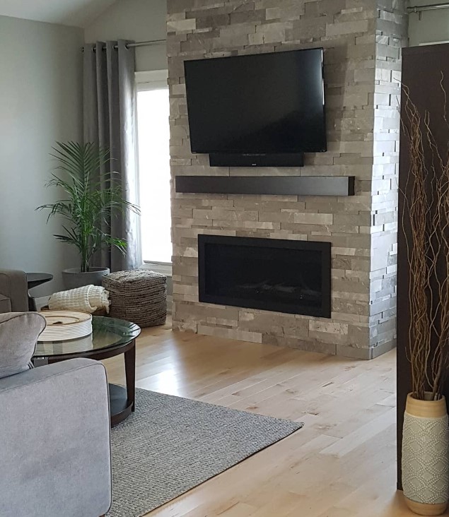 Raised stone Fireplace with Mounted TV