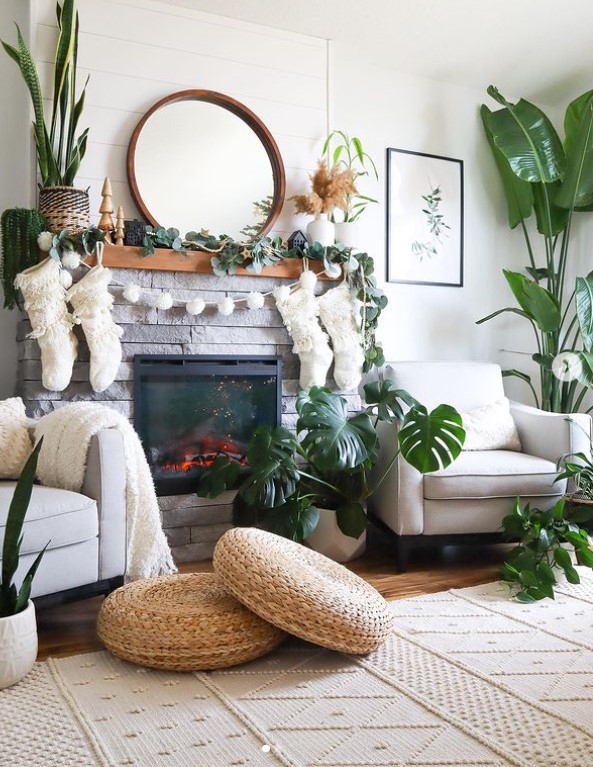 Add a fresh and vibrant touch to your mantel with Christmas decor featuring lively plants.